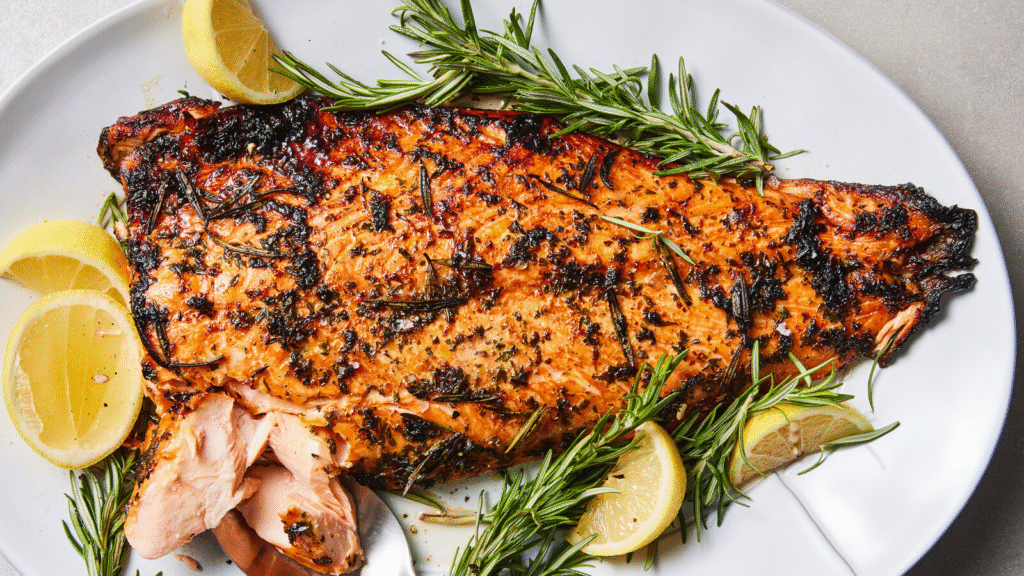 A generous, flaky piece of lemon herb baked salmon with a crispy herb crust and charred lemon slices—your new favorite foolproof healthy dinner